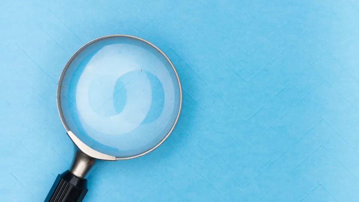 Magnifying glass on a blue background